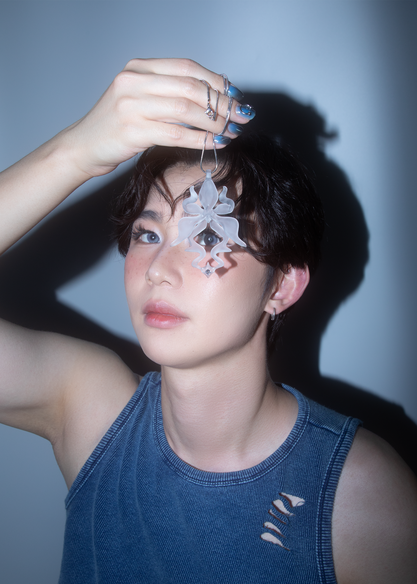 Model holding translucent/transparent 3D printed resin orchid necklace with gemstone