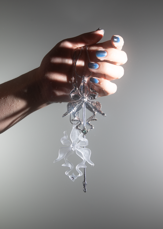 Model holding translucent/transparent & silver-plated 3D printed resin orchid necklace with gemstone