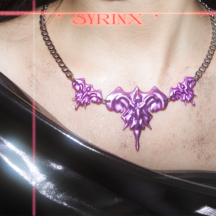 Model wearing 3D printed necklace earrings set with purple metalic finish