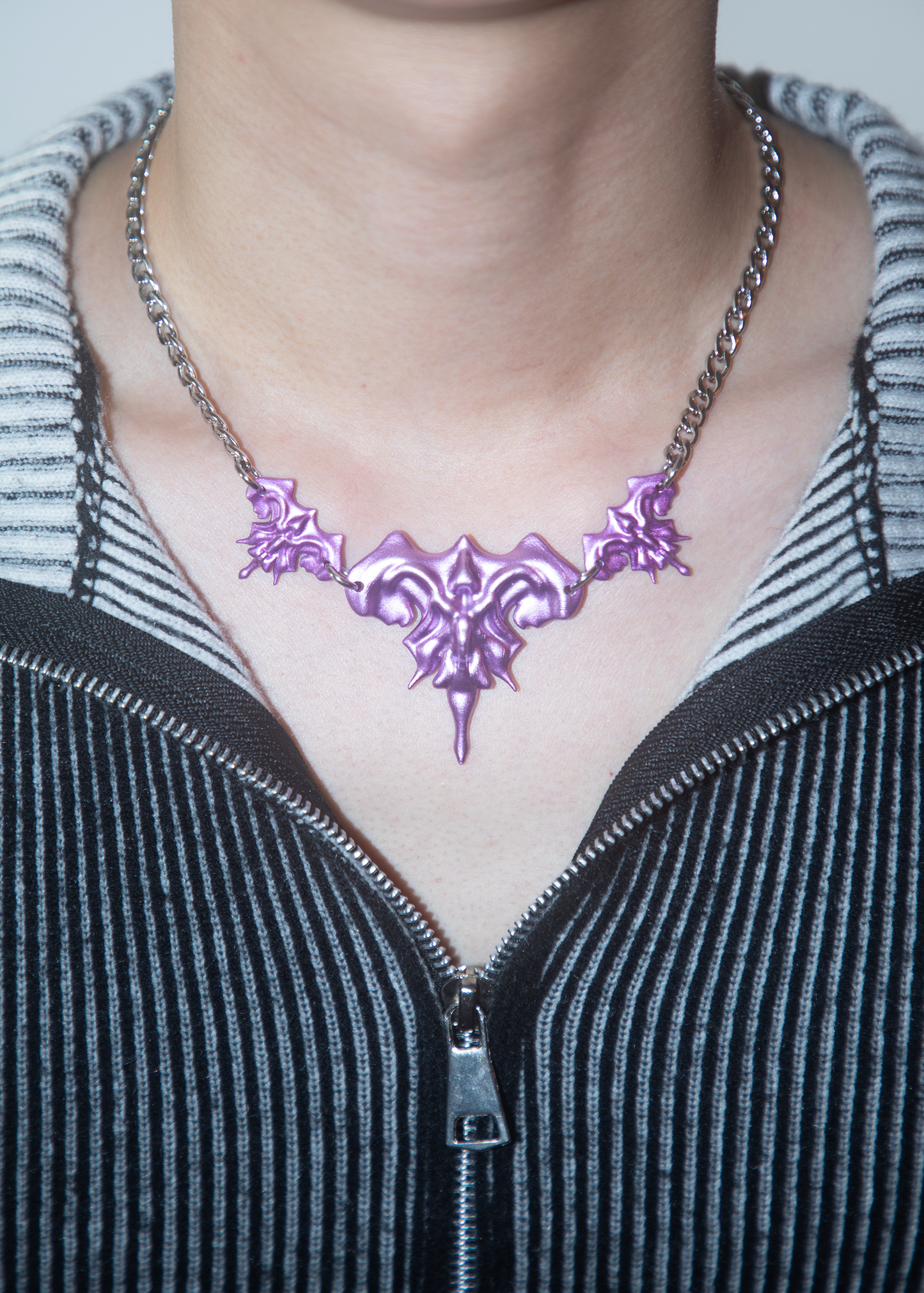 Model wearing 3D printed necklace earrings set with purple metalic finish
