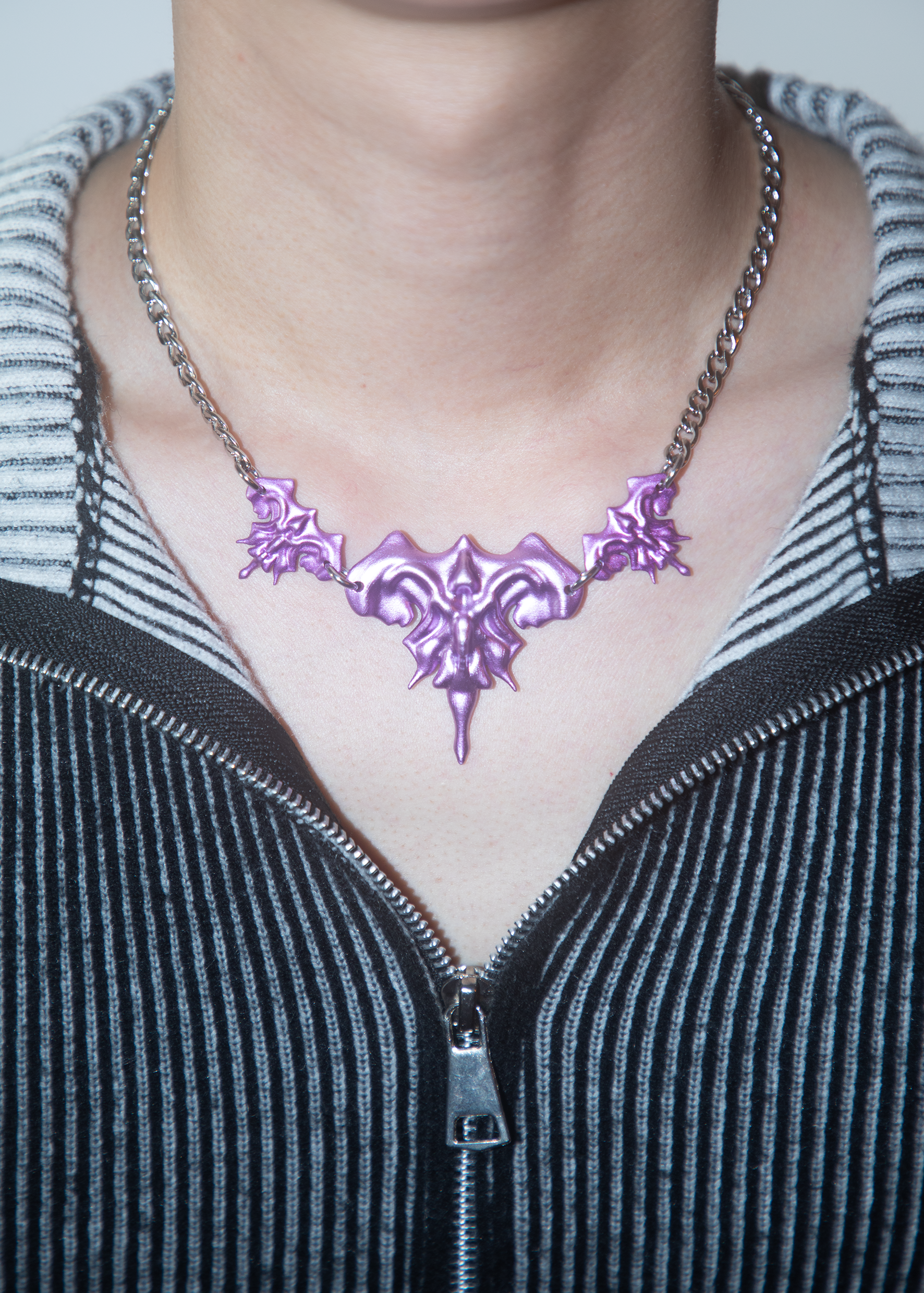 Model wearing 3D printed necklace earrings set with purple metalic finish