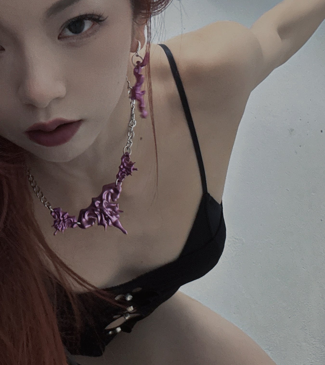 Model wearing 3D printed necklace earrings set with purple metalic finish